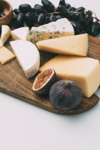 Close up of cheese platter with grapes and different cheeses