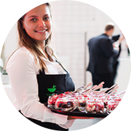 Friendly catering staff with tray of appetizers