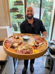 Smiling Chef Paul-Vincent with a large cheese and crudite board