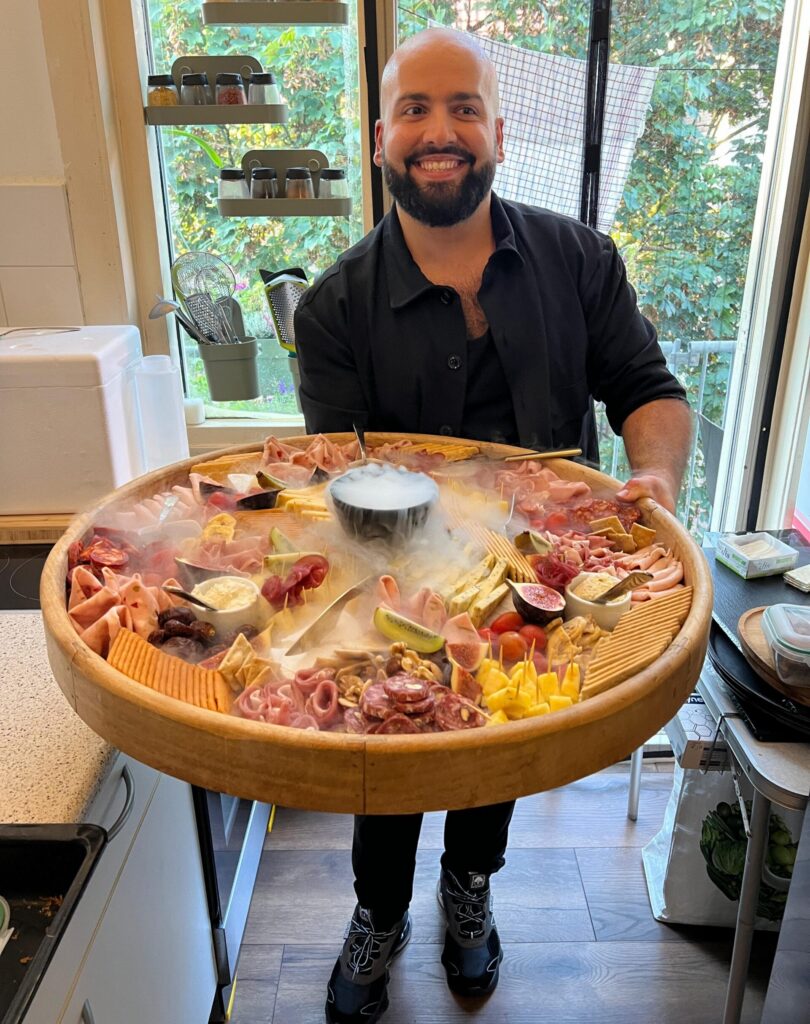 Smiling Chef Paul-Vincent with a large cheese and crudite board