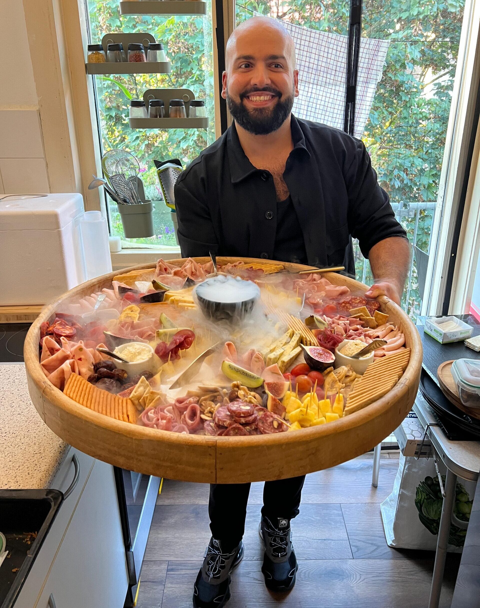 Smiling Chef Paul-Vincent with a large cheese and crudite board